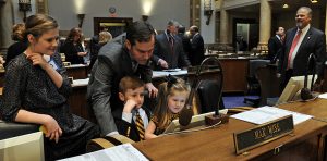 man showing children how to vote in the senate