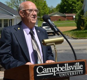 older man in suit at podium