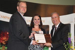 a man and woman receive plaque