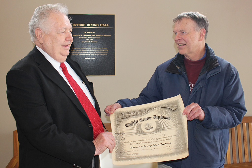 two men holding a diploma