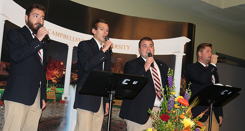 four men singing