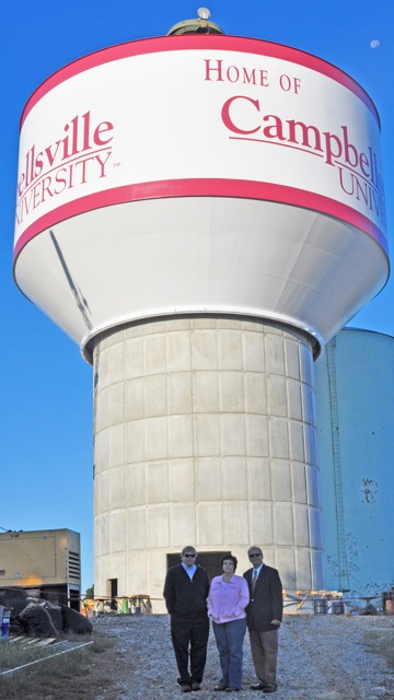 people standing in front of water tower