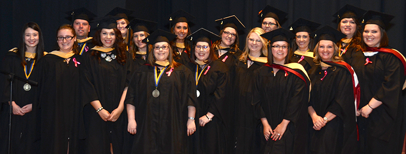 graduates posing for the camera