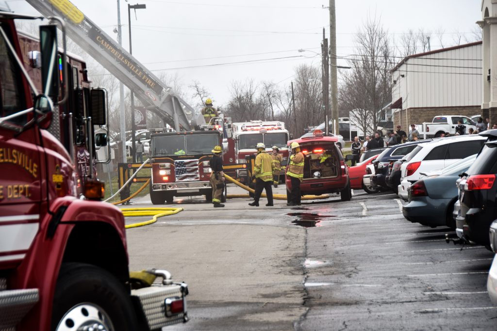 street filled with firefighters and trucks